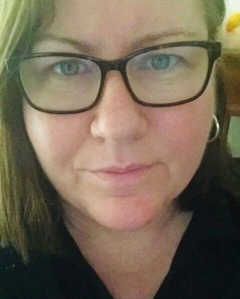 A closeup selfie of Deb, a lady with glasses, shoulder length brown hair and blue eyes.