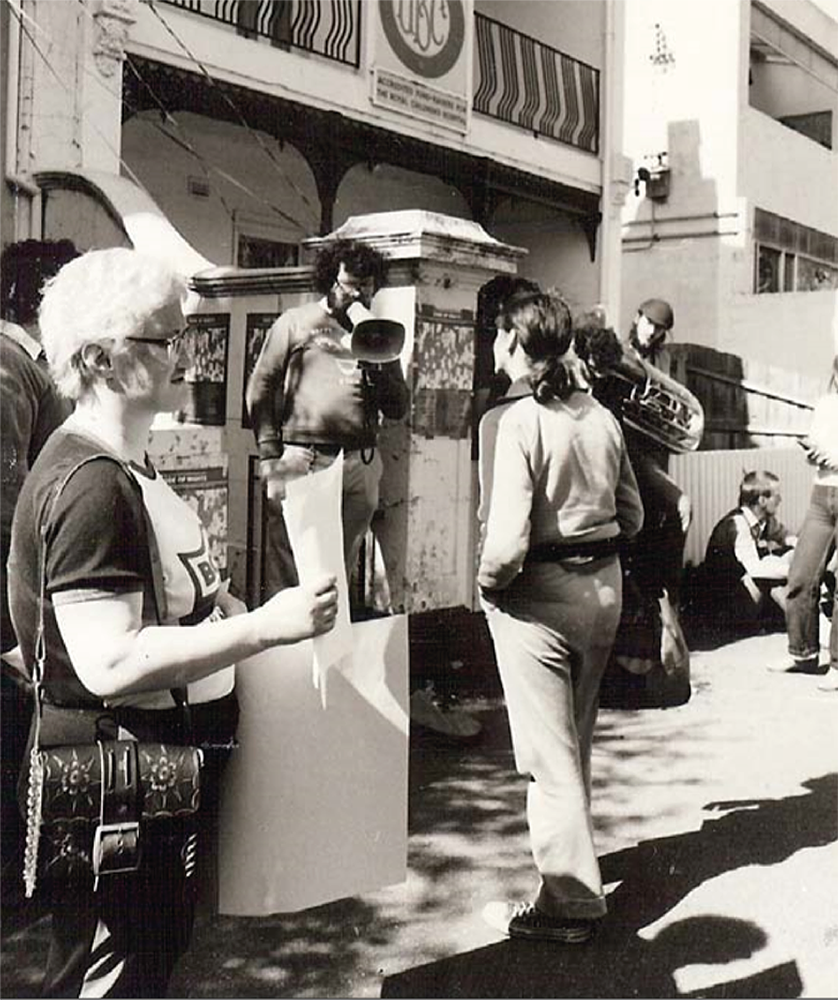 Image is of 112 Drummond Street protesters talking to passersby on the street.