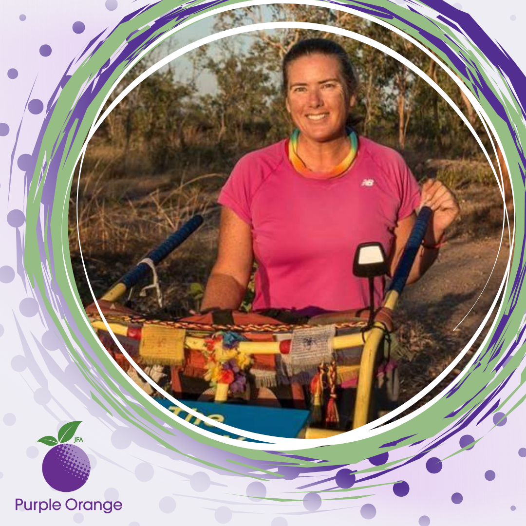 Spotty and circular background with purples and greens. Photo of Terra smiling during the trek around Aus.