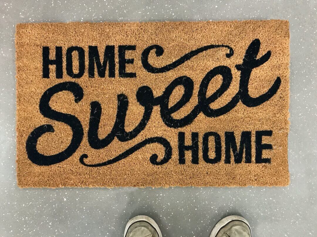Photo of a brown thatched doormat with words Home Sweet Home.