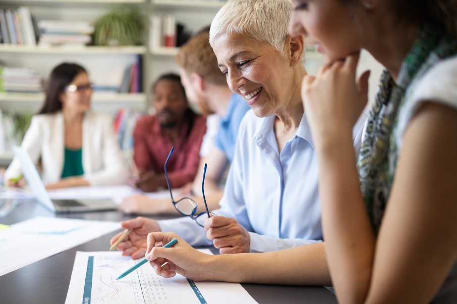 Diverse group of people working together Diverse group of people at a table working together.