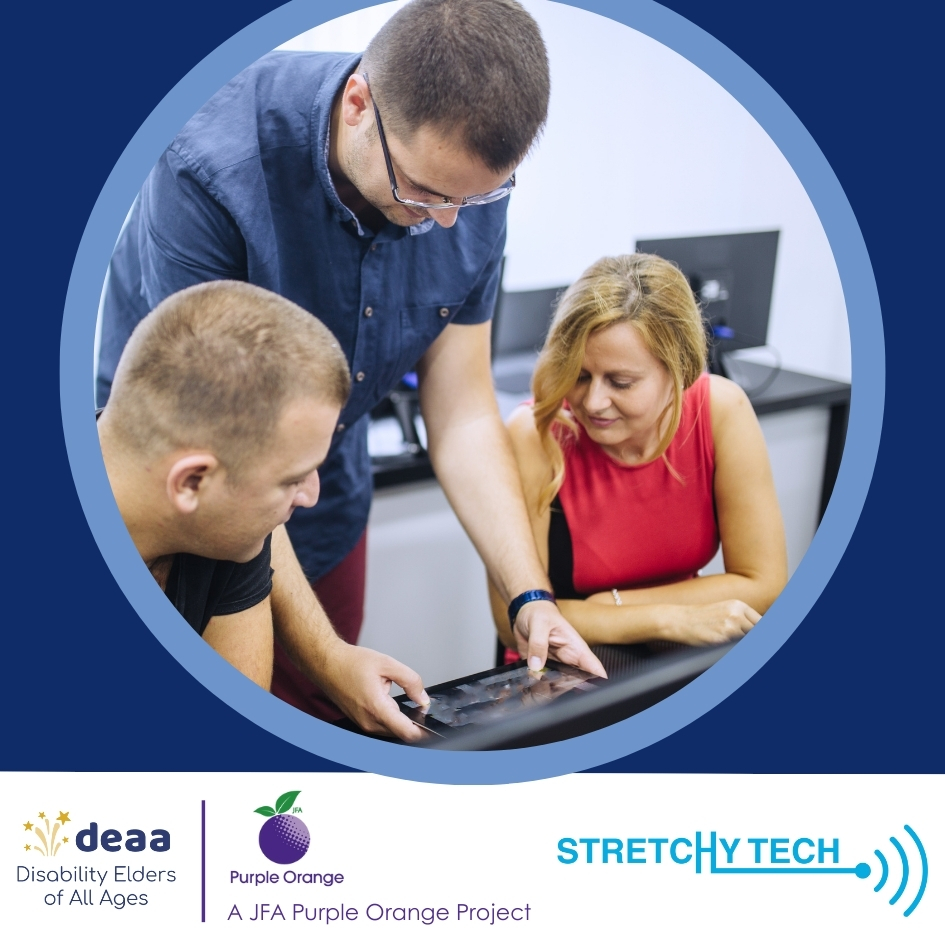 Connect with Tech workshops Image of man standing between a seated man and woman. They are all looking at an electronic tablet that is on a table in front of them.