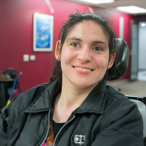 A woman with dark hair in a wheelchair