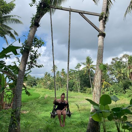 Photo of Jocelyn on a tree swing in Bali in nature