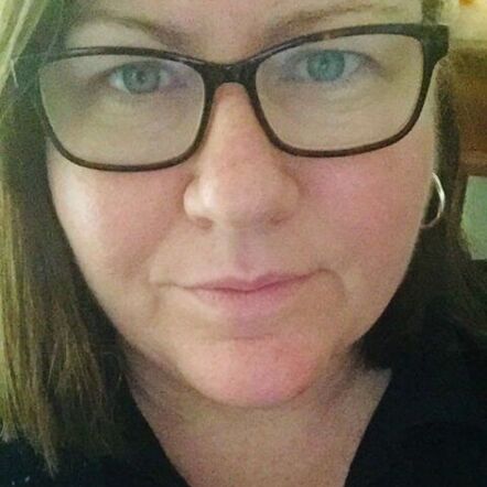 A closeup selfie of Deb, a lady with glasses, shoulder length brown hair and blue eyes.