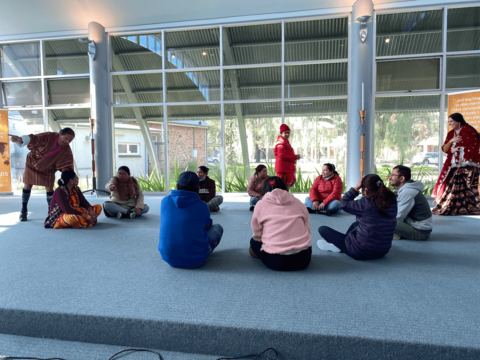 Photo of community members playing the handkerchief game. Community members enjoy the handkerchief game.